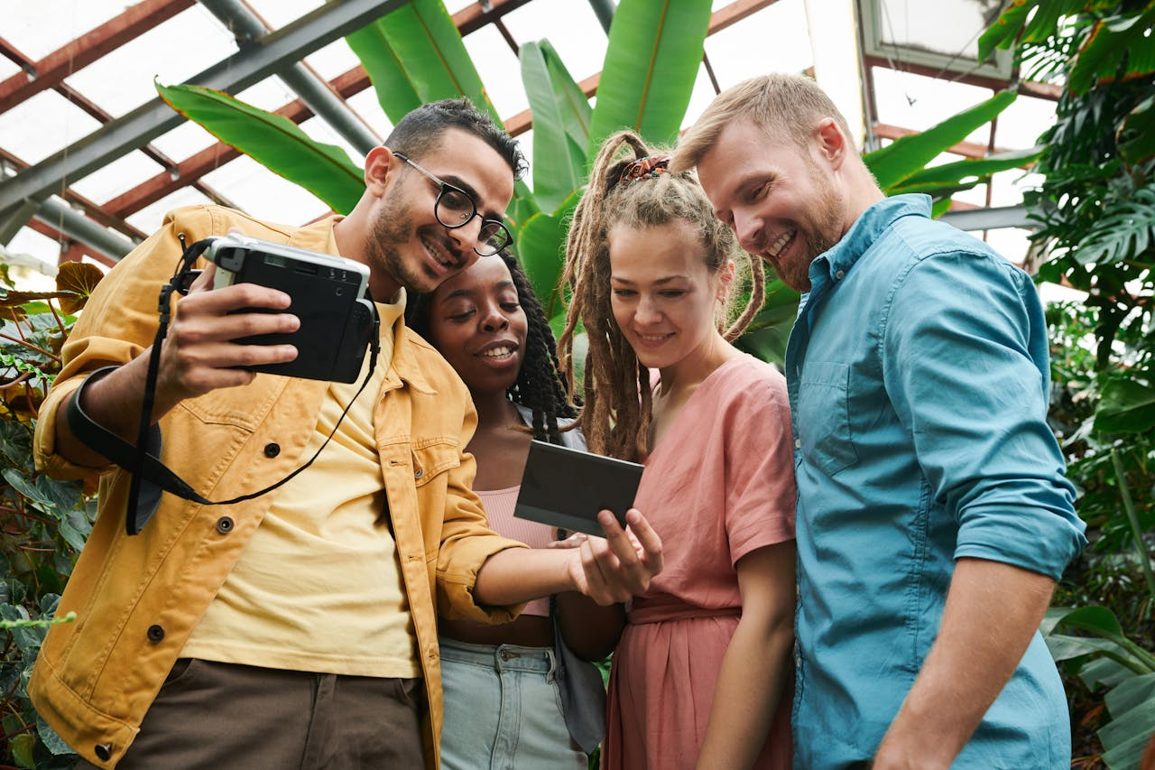 Crafting Captivating Headlines: Your awesome post title goes here A diverse group of friends smiling and viewing a Polaroid instant photo together outdoors.