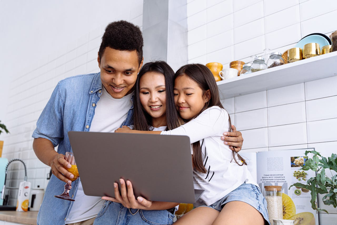 Mastering the First Impression: Your intriguing post title goes here A joyful family of three browsing content together on a laptop at home.